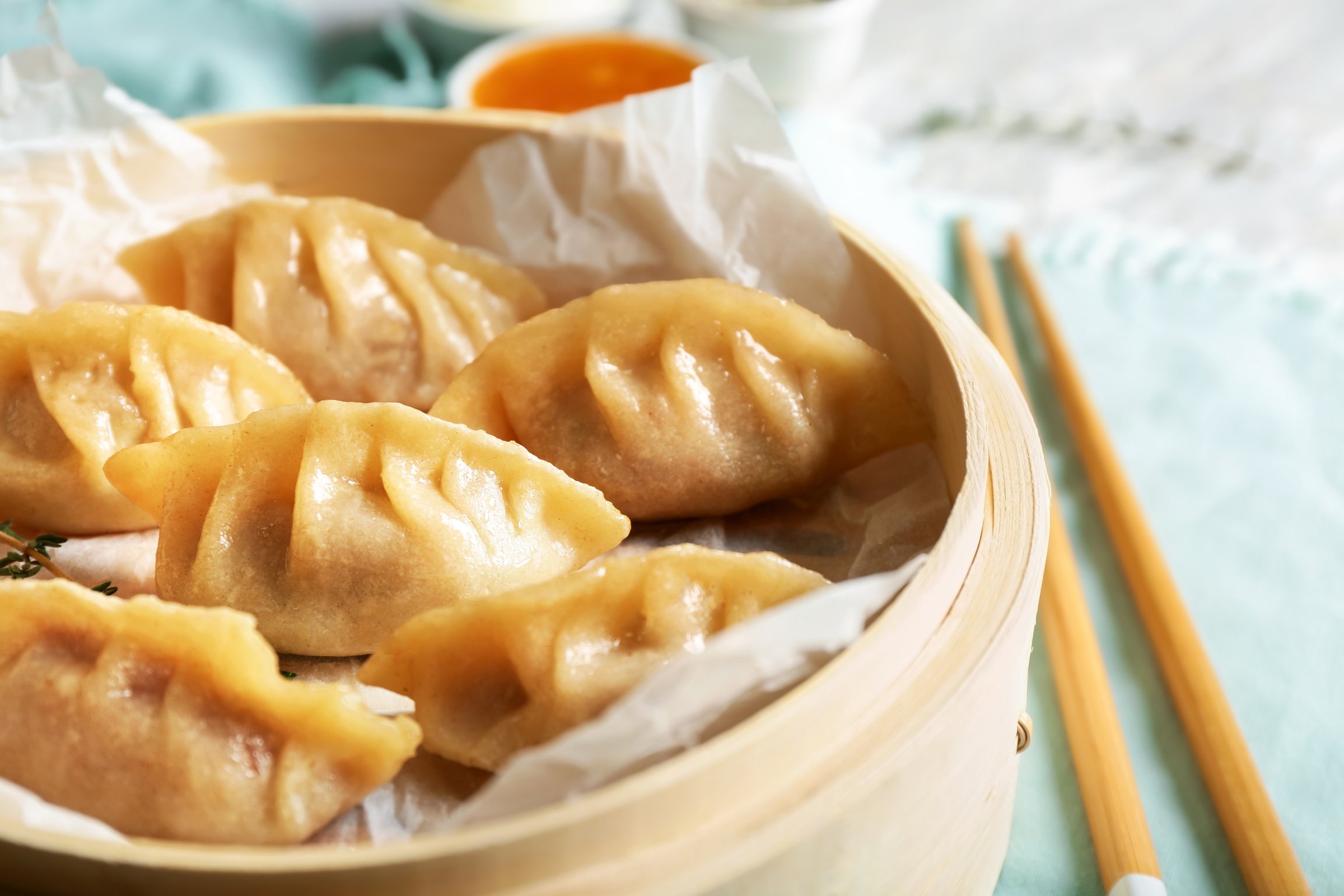 Bamboo Steamer with Tasty Japanese Gyoza on Table, Closeup